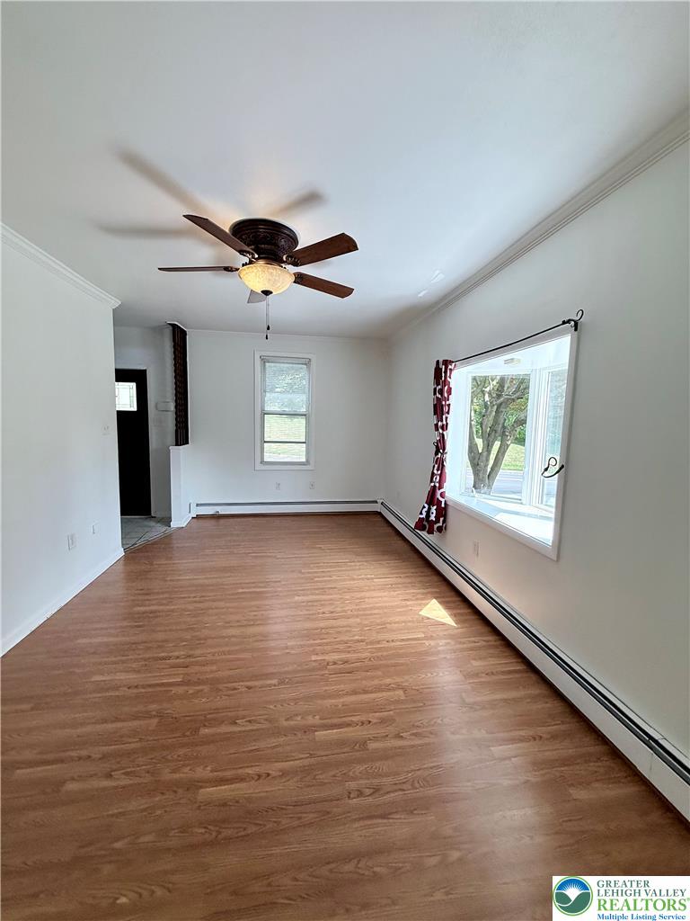 5540 Main Street Whitehall, PA 18052 - Photo 19 of 53 A spacious room features crown molding and durable laminate flooring.