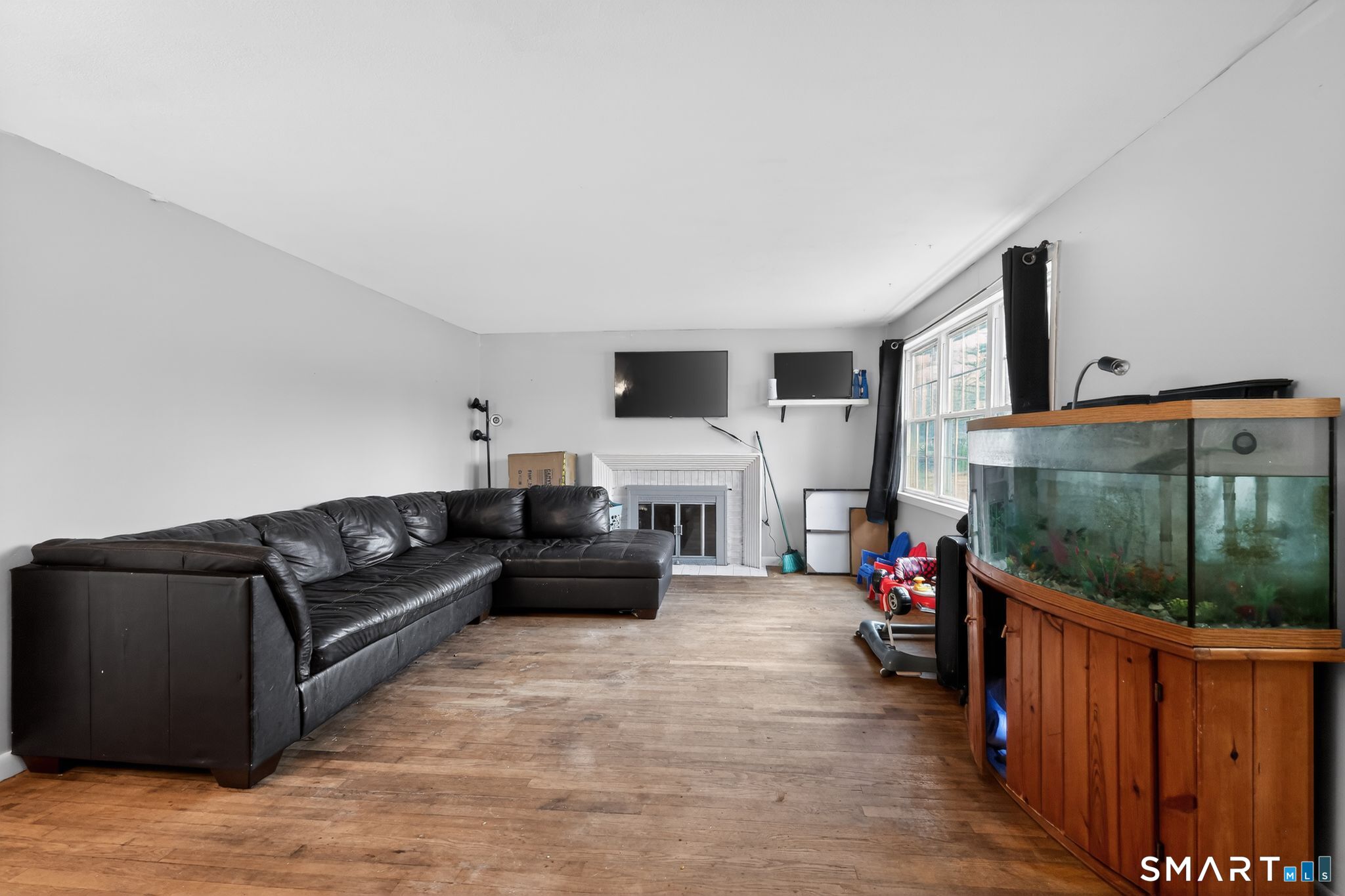 172 Bailey Hill Road Killingly, CT 06239 - Photo 4 of 35 a living room with furniture a flat screen tv and a floor to ceiling window