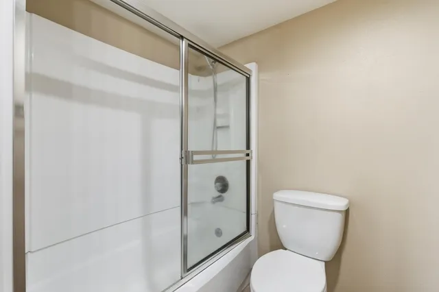 a bathroom with a toilet and a shower