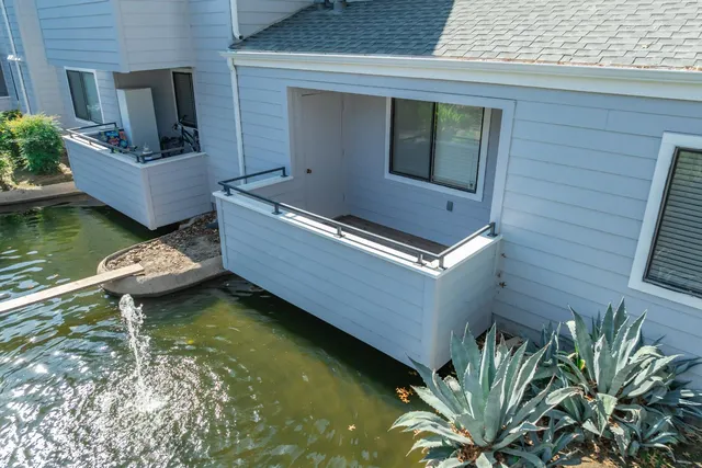 a view of house with pool and sitting area