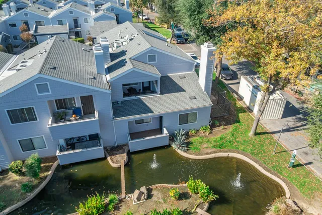 an aerial view of a house with a swimming pool and a yard