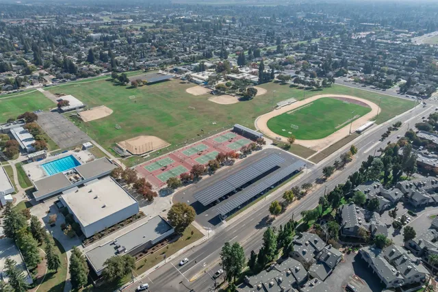 an aerial view of a house with a garden and lake view