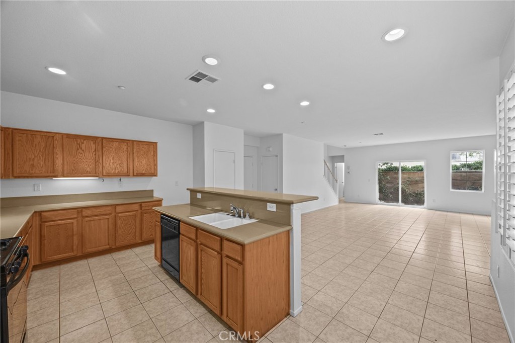 7353 Ellena West, Unit 112 Rancho Cucamonga, CA 91730 - Photo 11 of 36 a kitchen with a sink window and cabinets