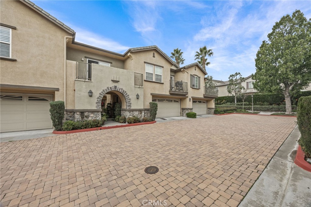 7353 Ellena West, Unit 112 Rancho Cucamonga, CA 91730 - Photo 2 of 36 a view of a house with a yard