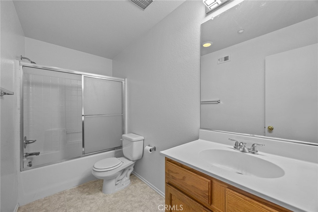 7353 Ellena West, Unit 112 Rancho Cucamonga, CA 91730 - Photo 24 of 36 a bathroom with a granite countertop sink toilet and shower
