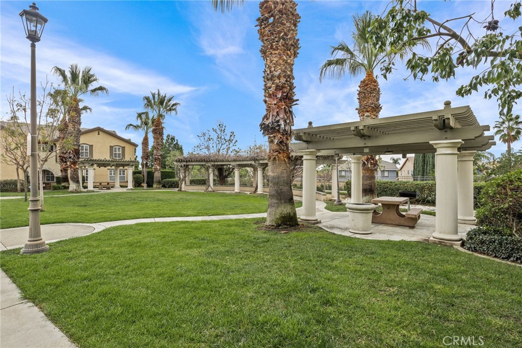 7353 Ellena West, Unit 112 Rancho Cucamonga, CA 91730 - Photo 30 of 36 a view of a house with a yard patio and fire pit