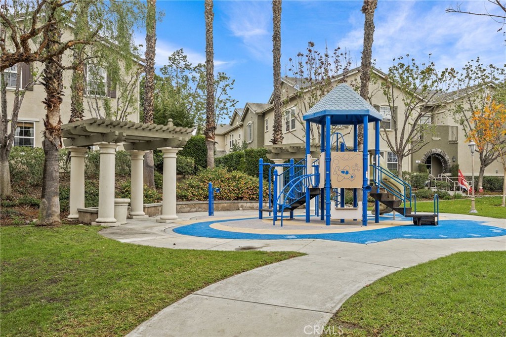 7353 Ellena West, Unit 112 Rancho Cucamonga, CA 91730 - Photo 32 of 36 a front view of a building with street and trees