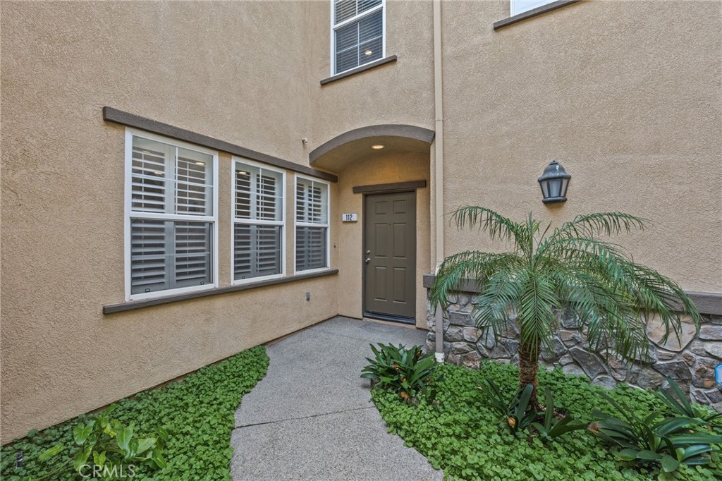 7353 Ellena West, Unit 112 Rancho Cucamonga, CA 91730 - Photo 4 of 36 a front view of a house with garden