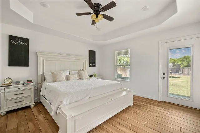 a spacious bedroom with a bed and a chandelier