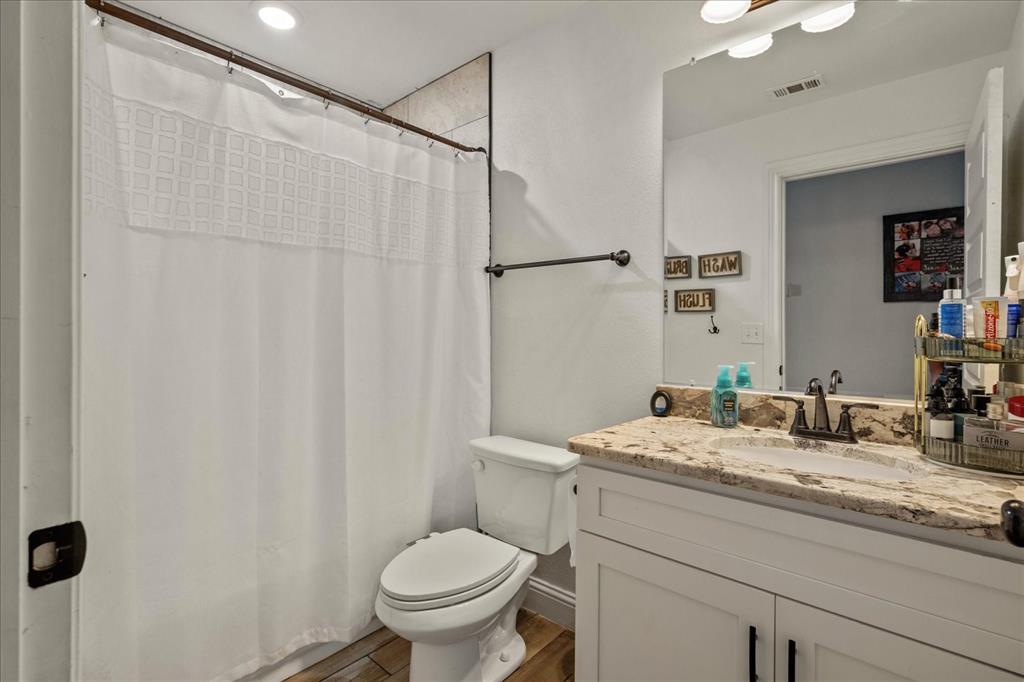 408 South Cedar Street Leonard, TX 75452 - Photo 17 of 22 a bathroom with a granite countertop sink toilet and shower