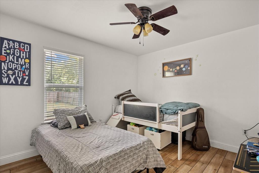 408 South Cedar Street Leonard, TX 75452 - Photo 18 of 22 a bedroom with a bed and a desk