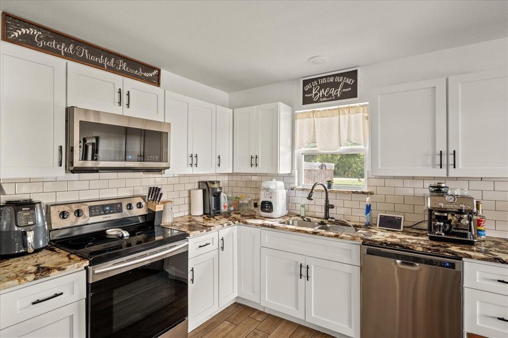 408 South Cedar Street Leonard, TX 75452 - Photo 10 of 22 a kitchen with granite countertop a stove sink and cabinets