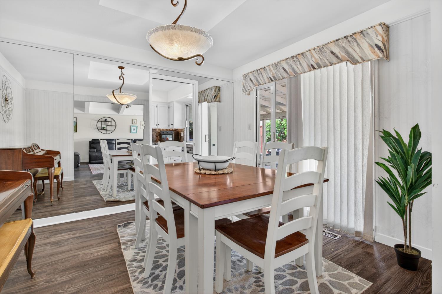 1909 Chelwood Way Modesto, CA 95355 - Photo 12 of 44 a kitchen with stainless steel appliances granite countertop a stove a sink dishwasher and white cabinets with wooden floor