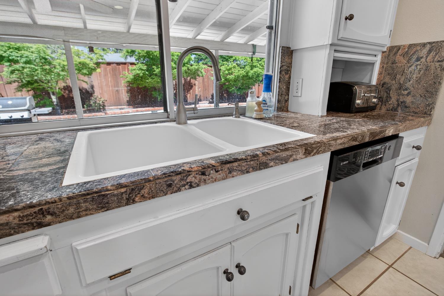 1909 Chelwood Way Modesto, CA 95355 - Photo 17 of 44 a kitchen with kitchen island a large window in it