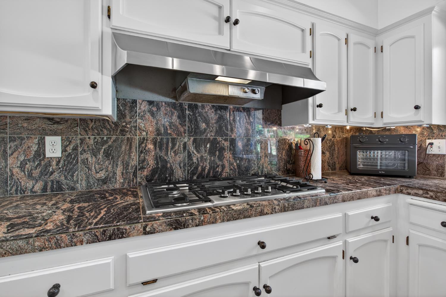 1909 Chelwood Way Modesto, CA 95355 - Photo 18 of 44 a kitchen with an oven a cabinets and a stove