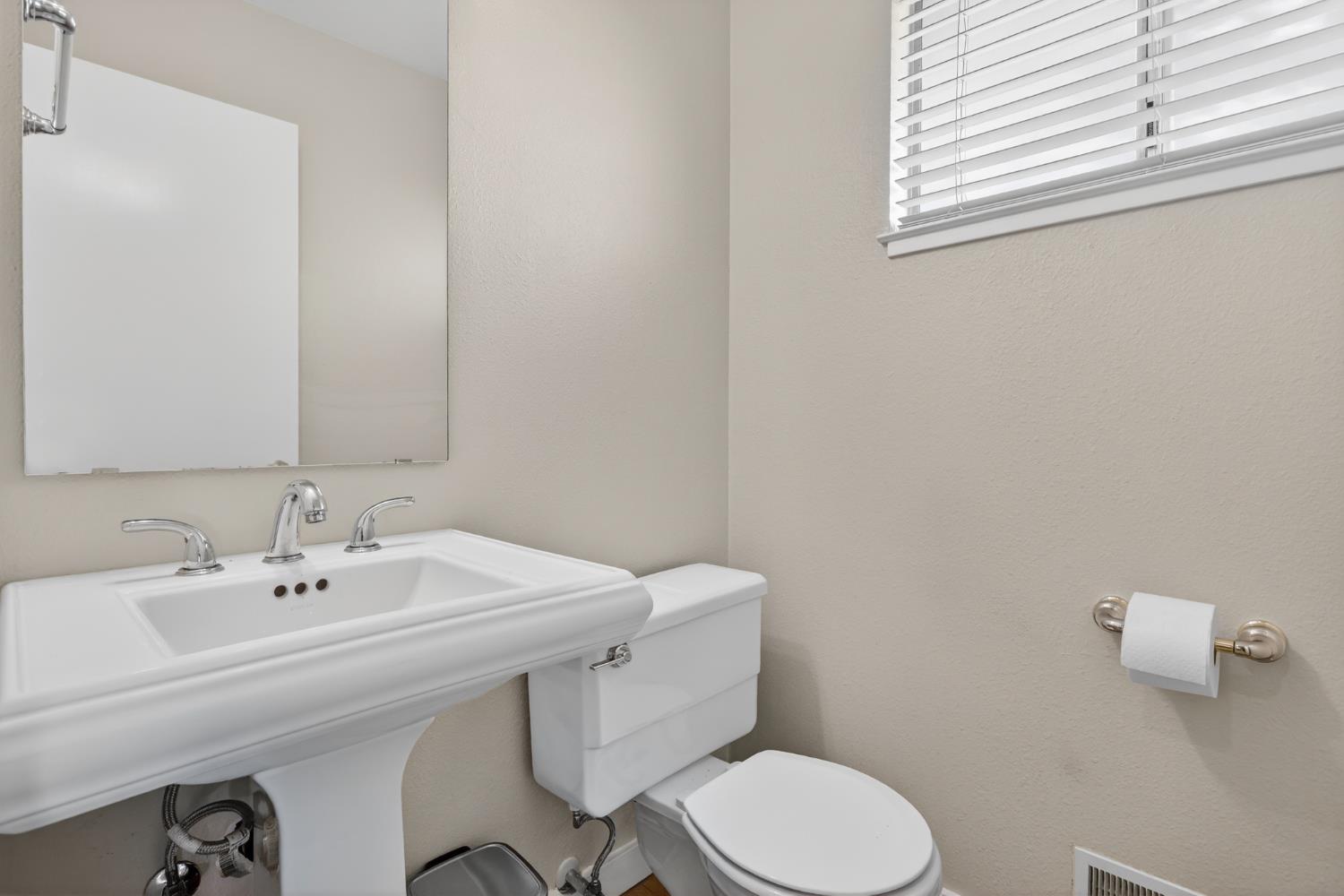 1909 Chelwood Way Modesto, CA 95355 - Photo 21 of 44 a bathroom with a sink a toilet and a mirror
