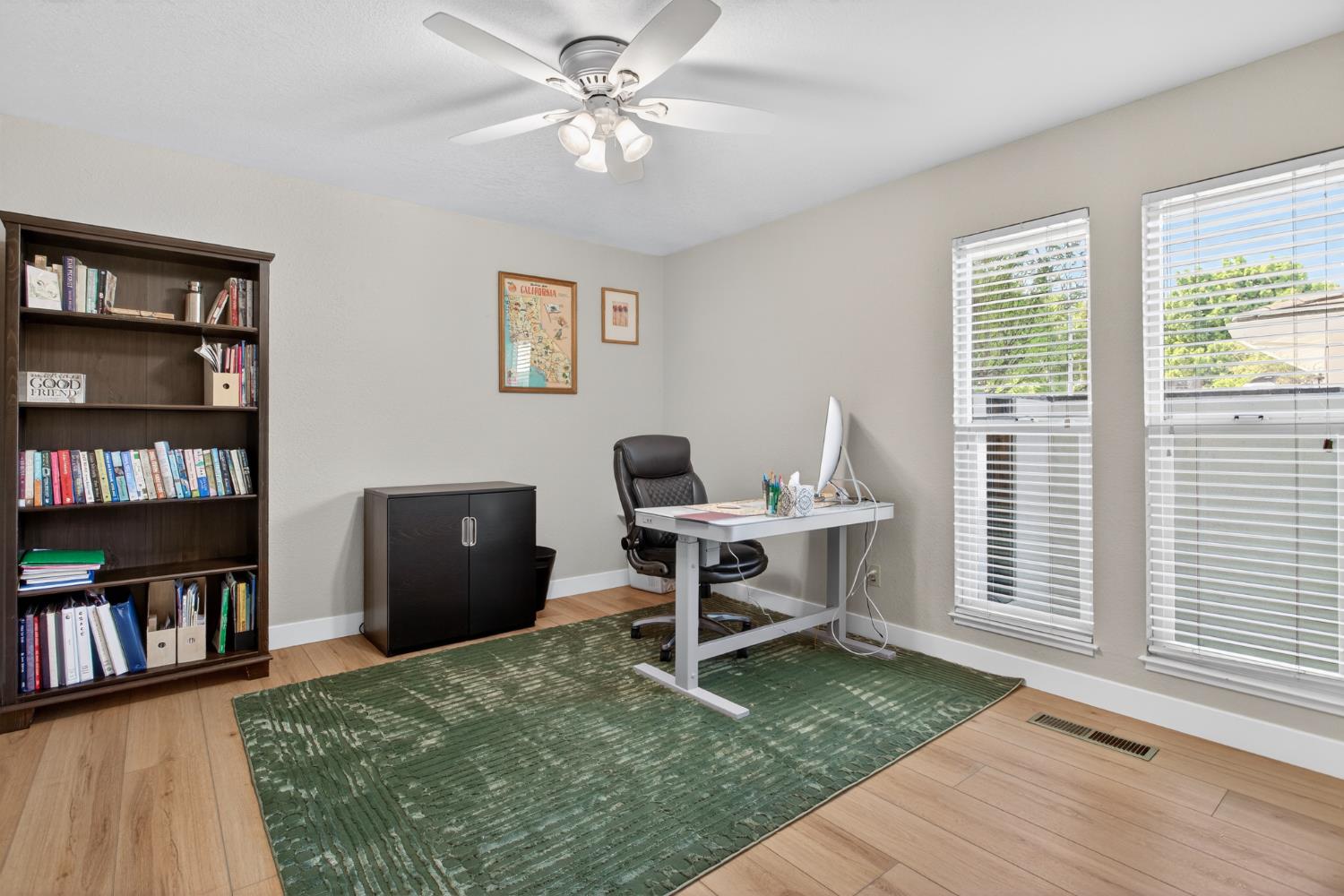 1909 Chelwood Way Modesto, CA 95355 - Photo 22 of 44 a view of a workspace with furniture and a bookshelf