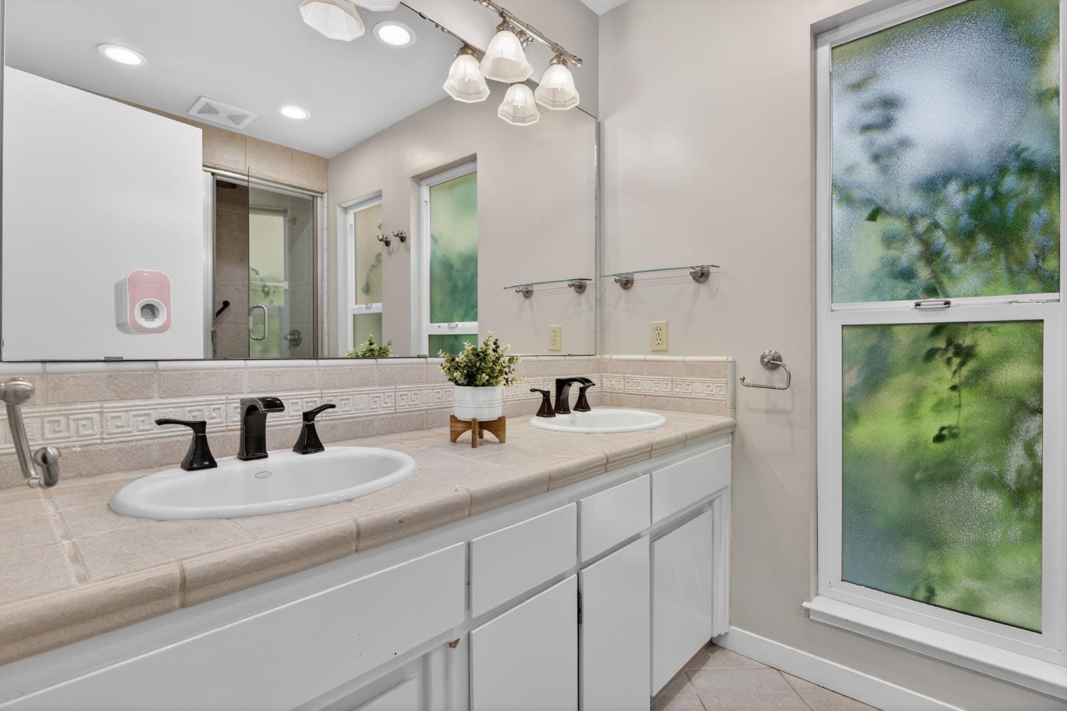1909 Chelwood Way Modesto, CA 95355 - Photo 25 of 44 a bathroom with a double vanity sink mirror and shower