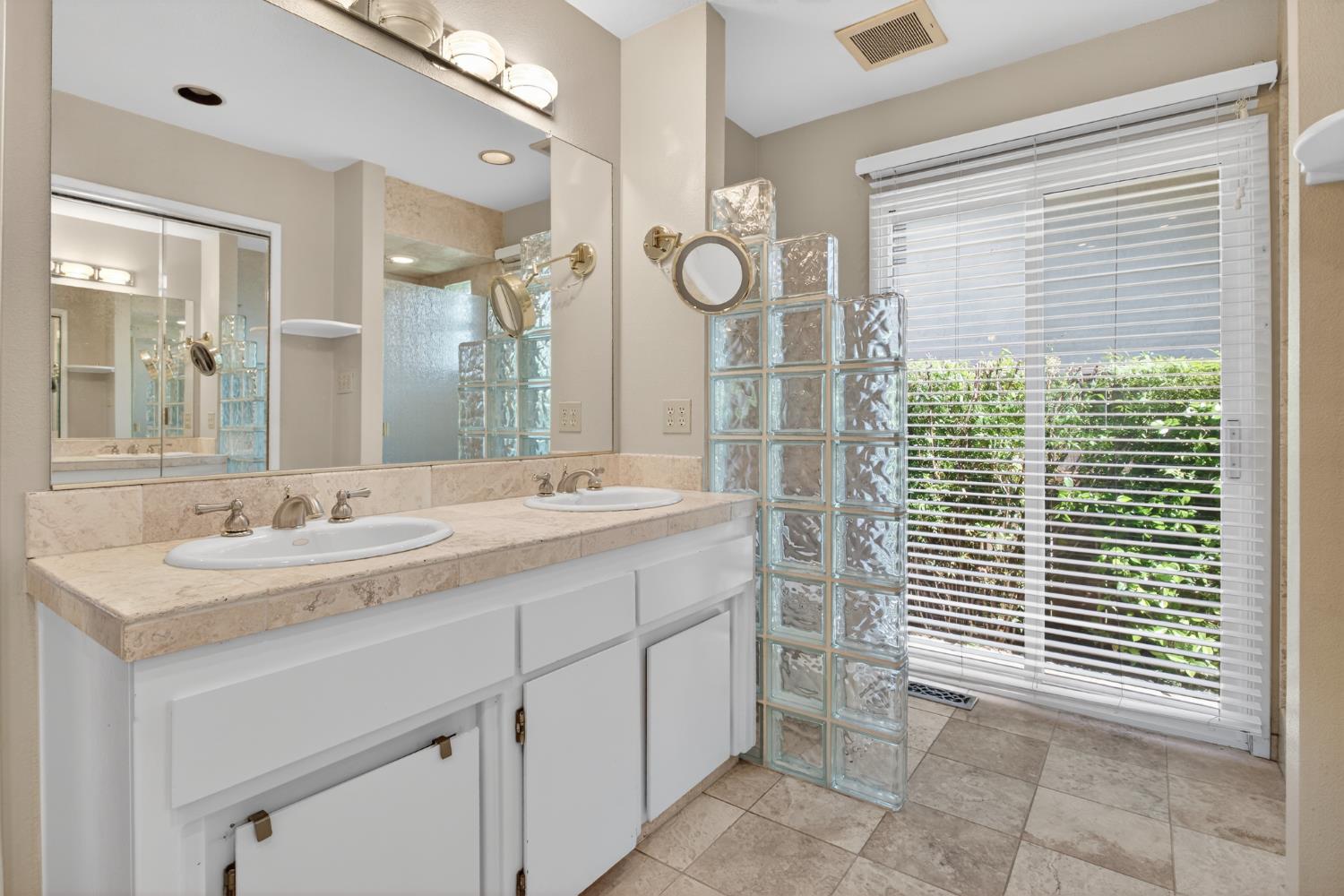 1909 Chelwood Way Modesto, CA 95355 - Photo 31 of 44 a bathroom with a sink a mirror and a shower