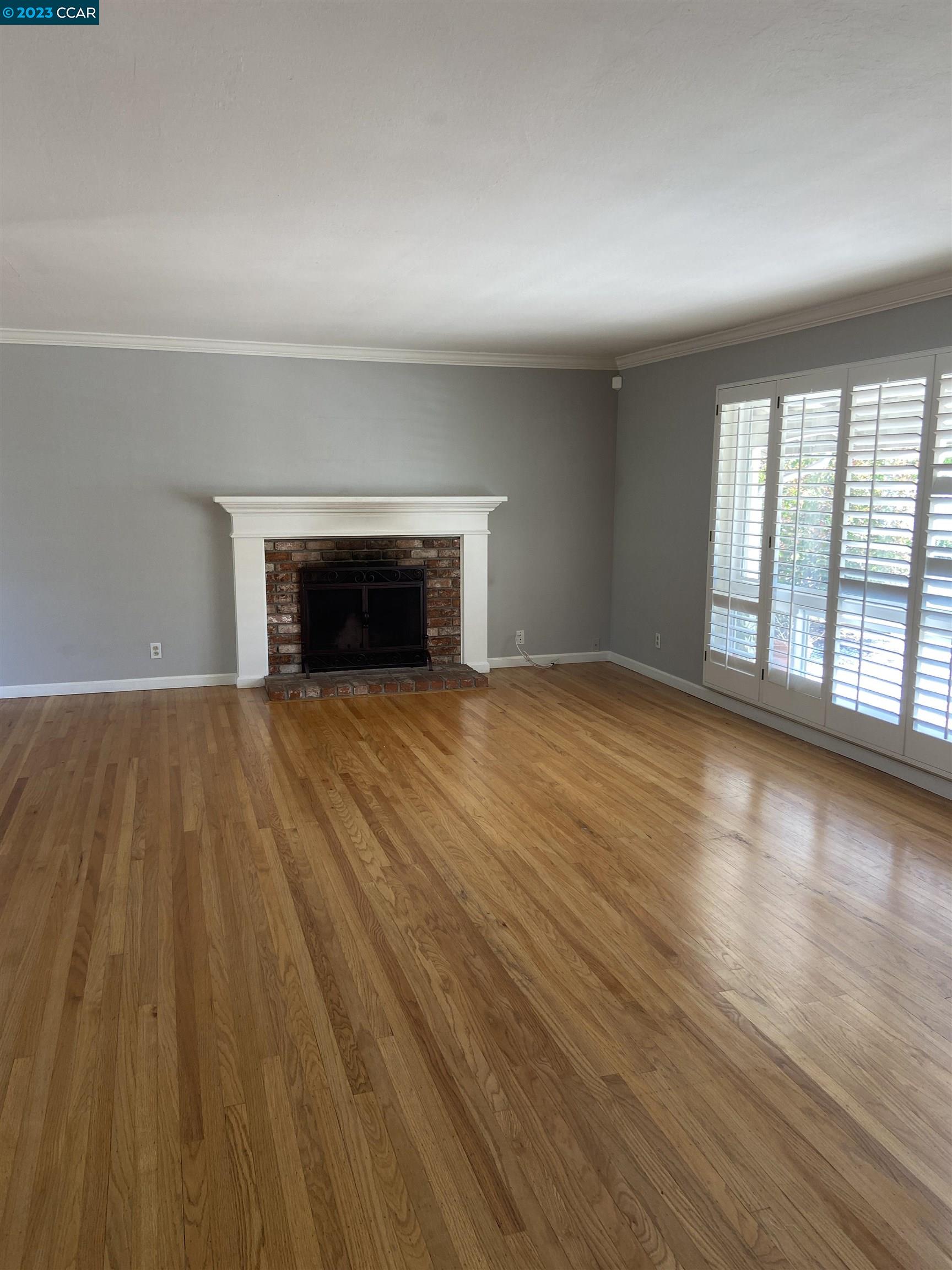 2202 Cascade Drive Walnut Creek, CA 94598 - Photo 3 of 23 wooden floor fireplace and windows in an empty room
