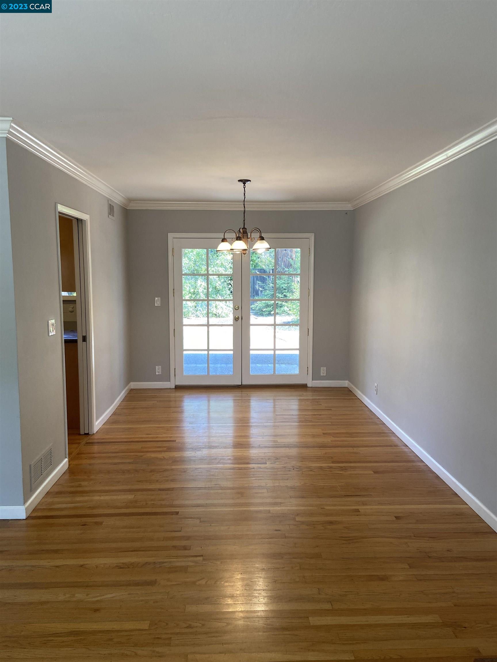 2202 Cascade Drive Walnut Creek, CA 94598 - Photo 4 of 23 an empty room with wooden floor and windows