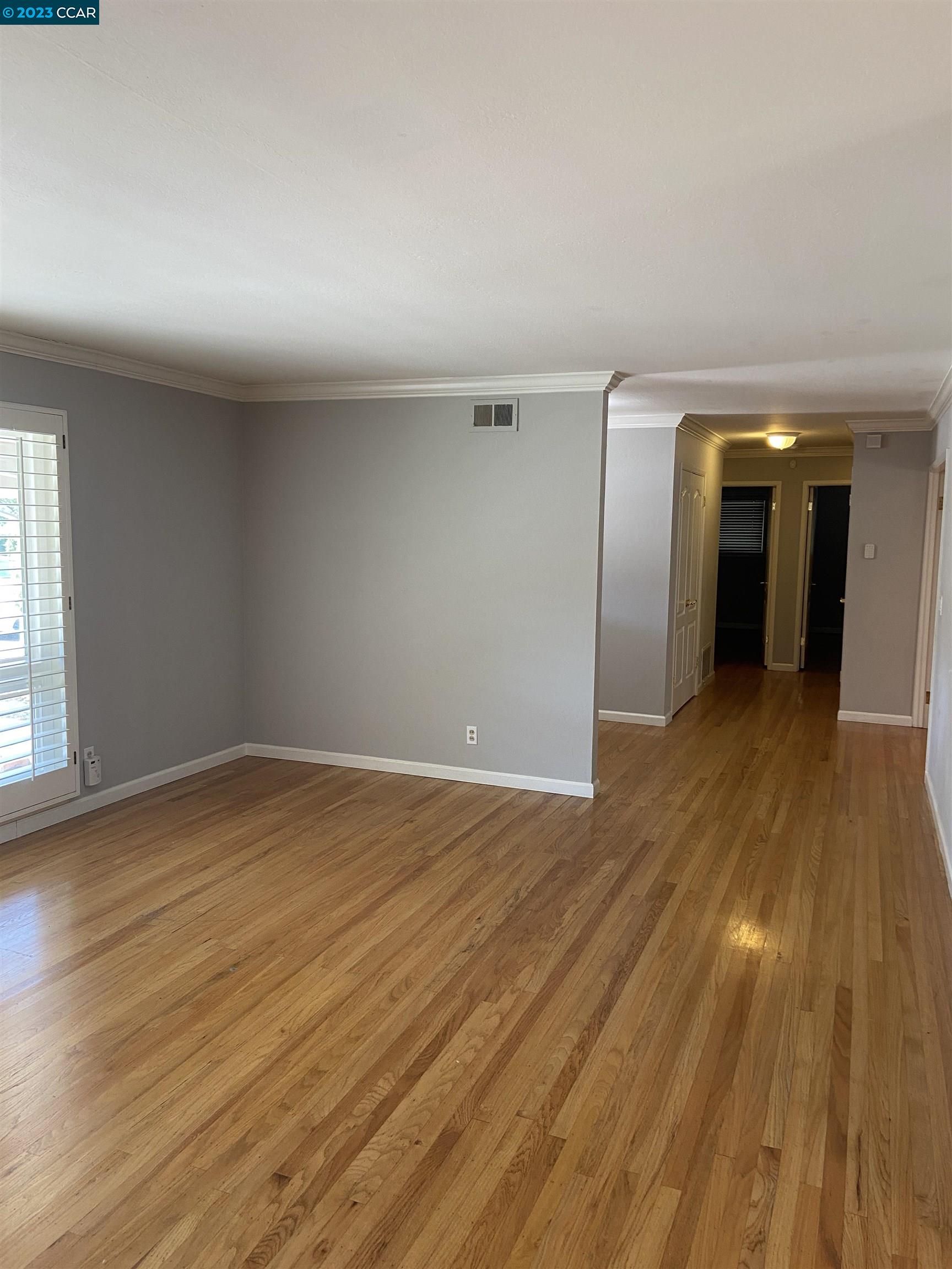 2202 Cascade Drive Walnut Creek, CA 94598 - Photo 5 of 23 an empty room with wooden floor and natural light