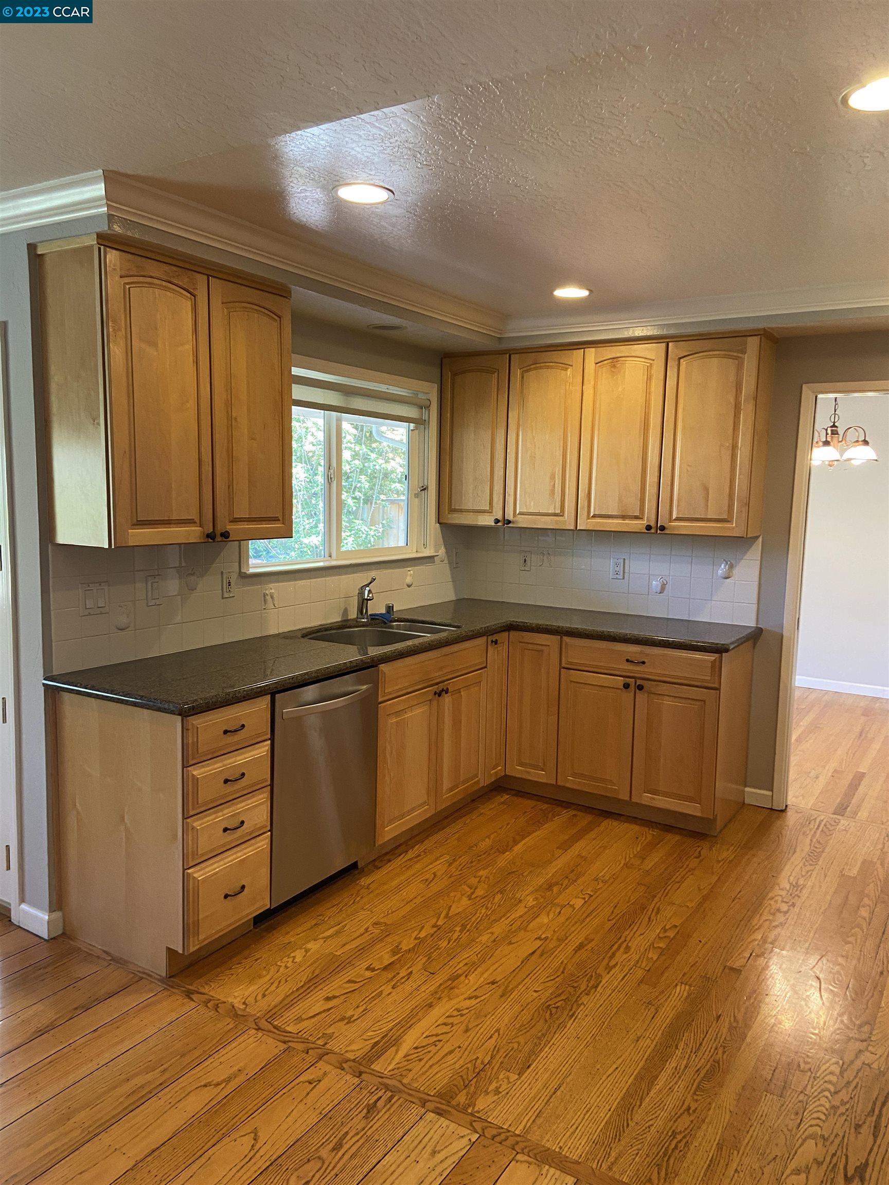 2202 Cascade Drive Walnut Creek, CA 94598 - Photo 8 of 23 a kitchen with stainless steel appliances granite countertop a sink and cabinets