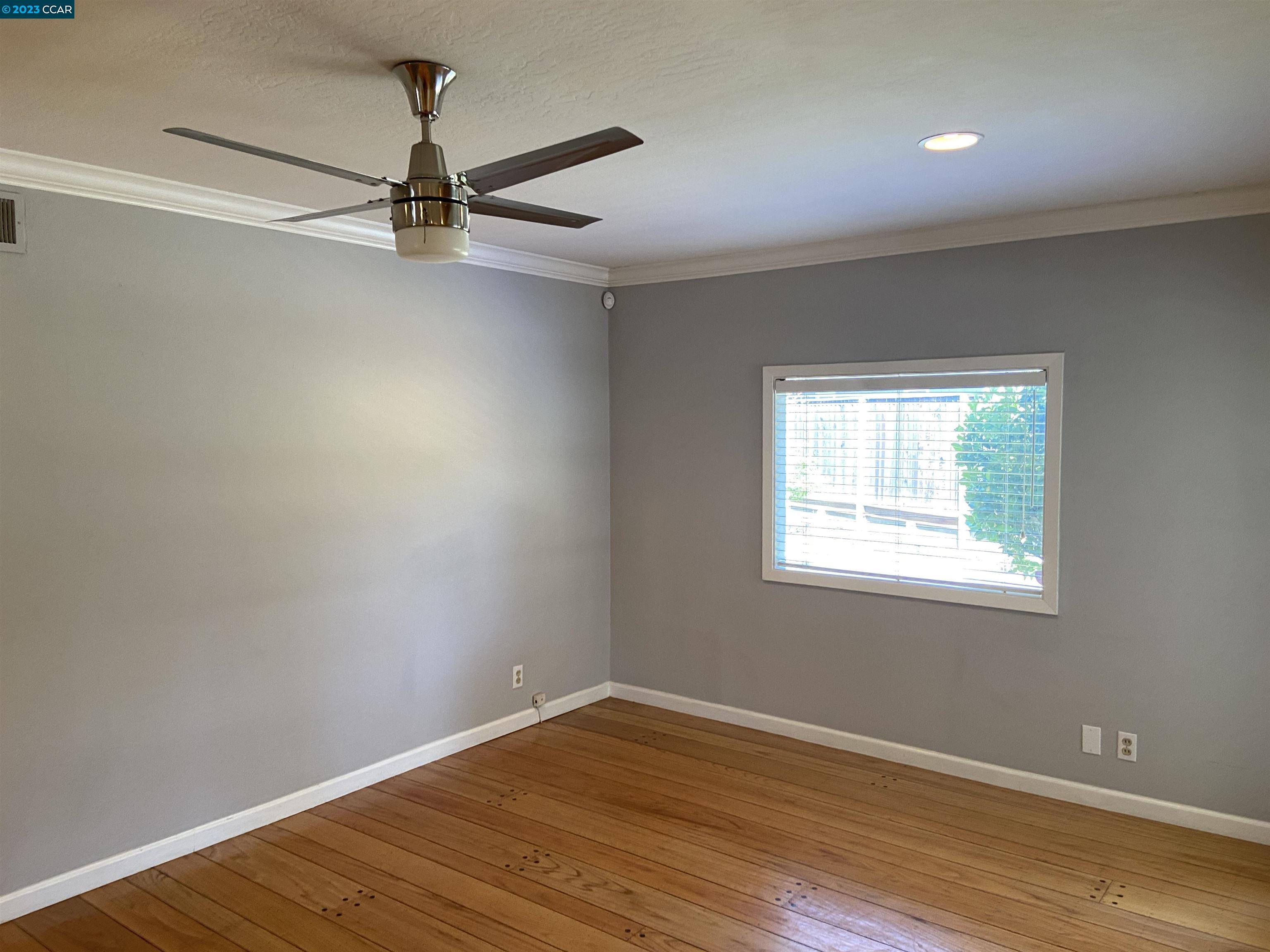 2202 Cascade Drive Walnut Creek, CA 94598 - Photo 9 of 23 an empty room with wooden floor closet and windows