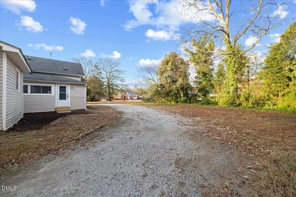 a view of a house with a yard and garage