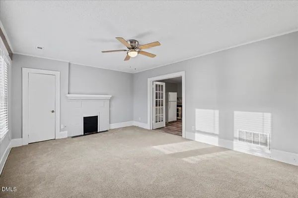 a view of empty room with fireplace