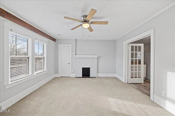 a view of a livingroom with a ceiling fan and window