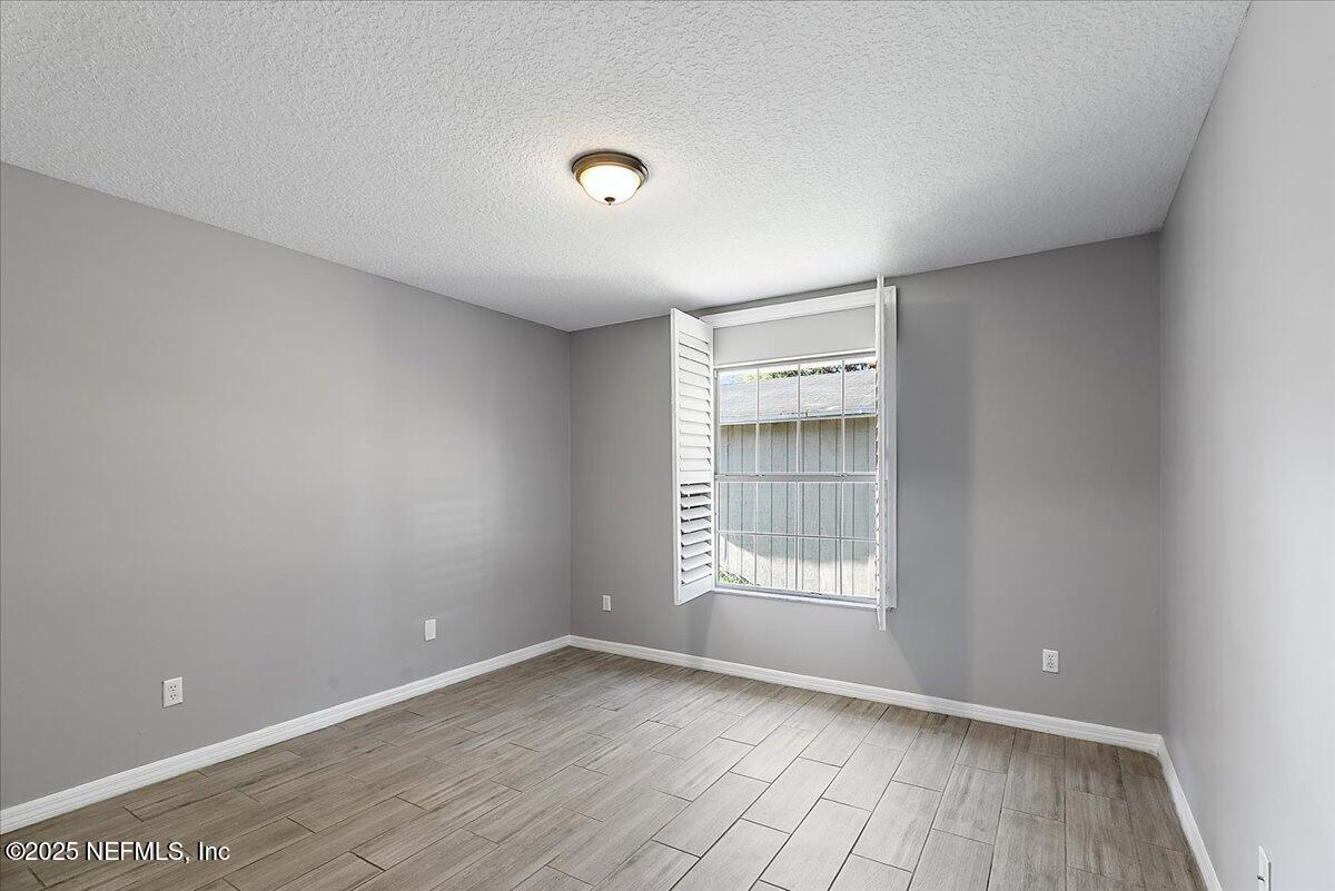 1315 Fruit Cove Road South Jacksonville, FL 32259 - Photo 13 of 19 a view of an empty room with wooden floor and a window