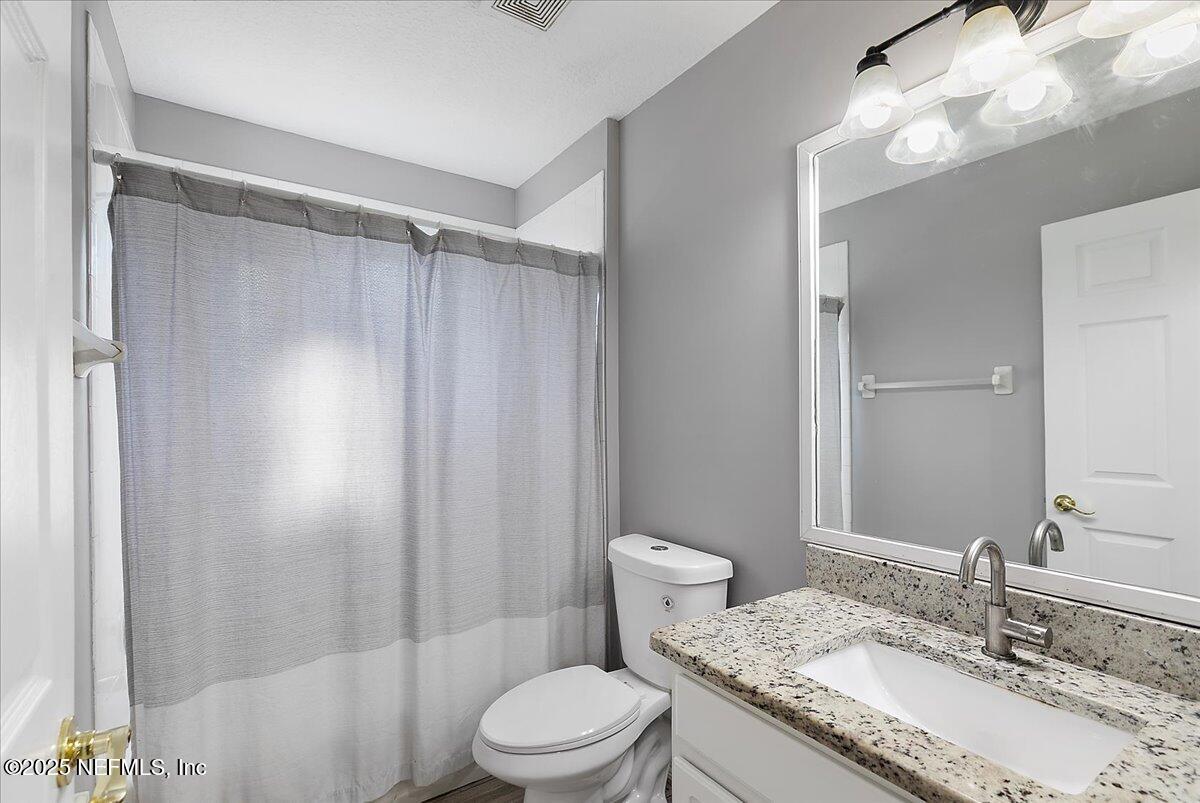 1315 Fruit Cove Road South Jacksonville, FL 32259 - Photo 14 of 19 a bathroom with a granite countertop sink toilet and shower