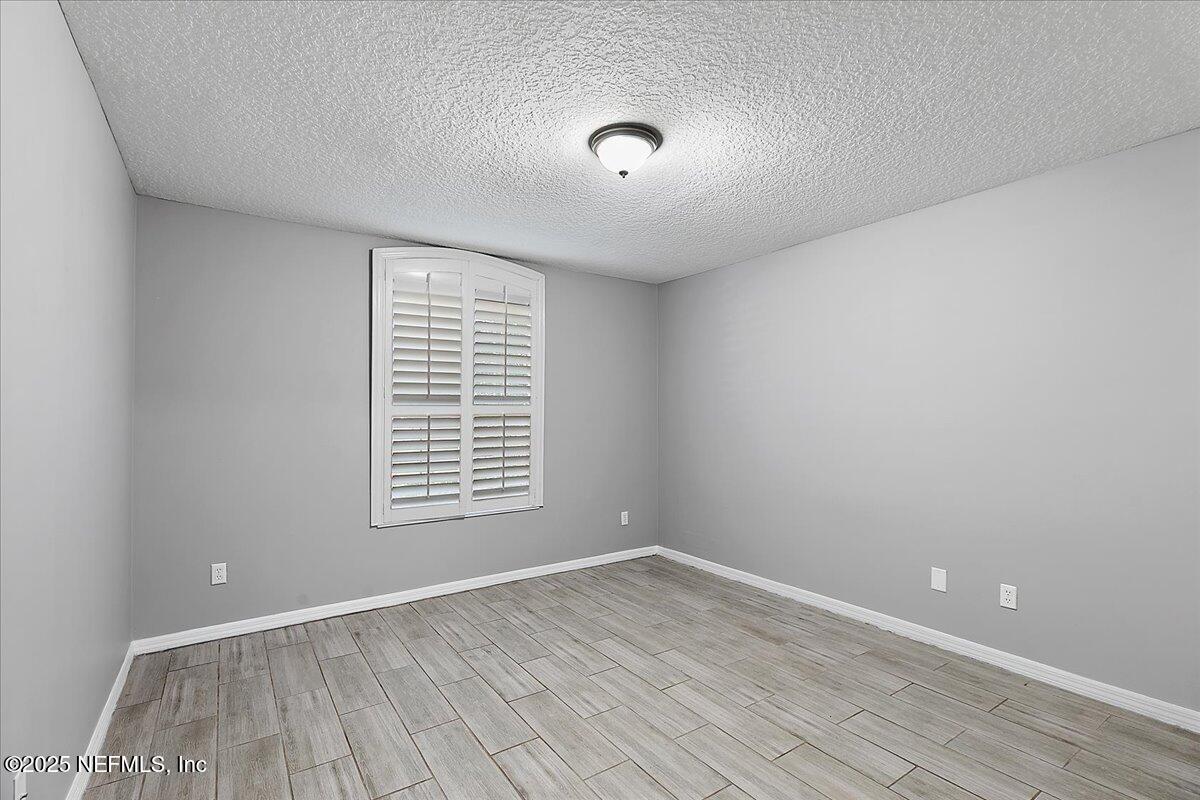 1315 Fruit Cove Road South Jacksonville, FL 32259 - Photo 15 of 19 a view of an empty room with wooden floor and a window