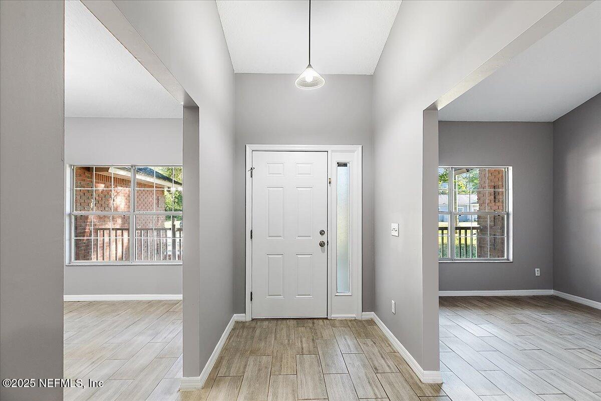 1315 Fruit Cove Road South Jacksonville, FL 32259 - Photo 3 of 19 a view of hallway with a large window and wooden floor