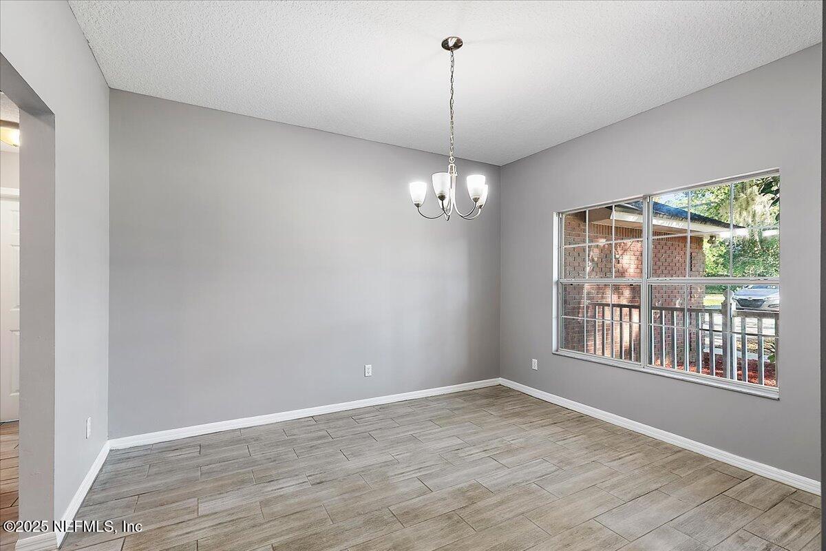 1315 Fruit Cove Road South Jacksonville, FL 32259 - Photo 4 of 19 a view of an empty room with wooden floor and a window