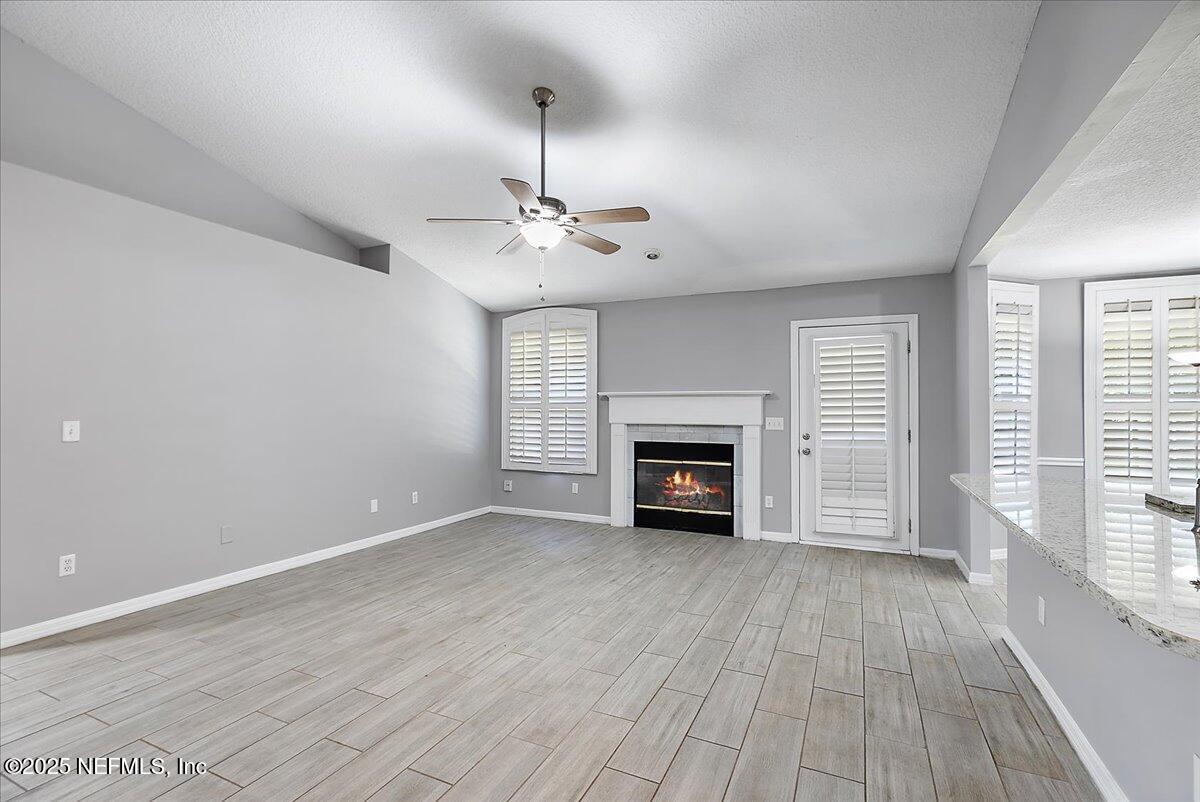 1315 Fruit Cove Road South Jacksonville, FL 32259 - Photo 6 of 19 a view of an empty room with wooden floor fireplace and a window