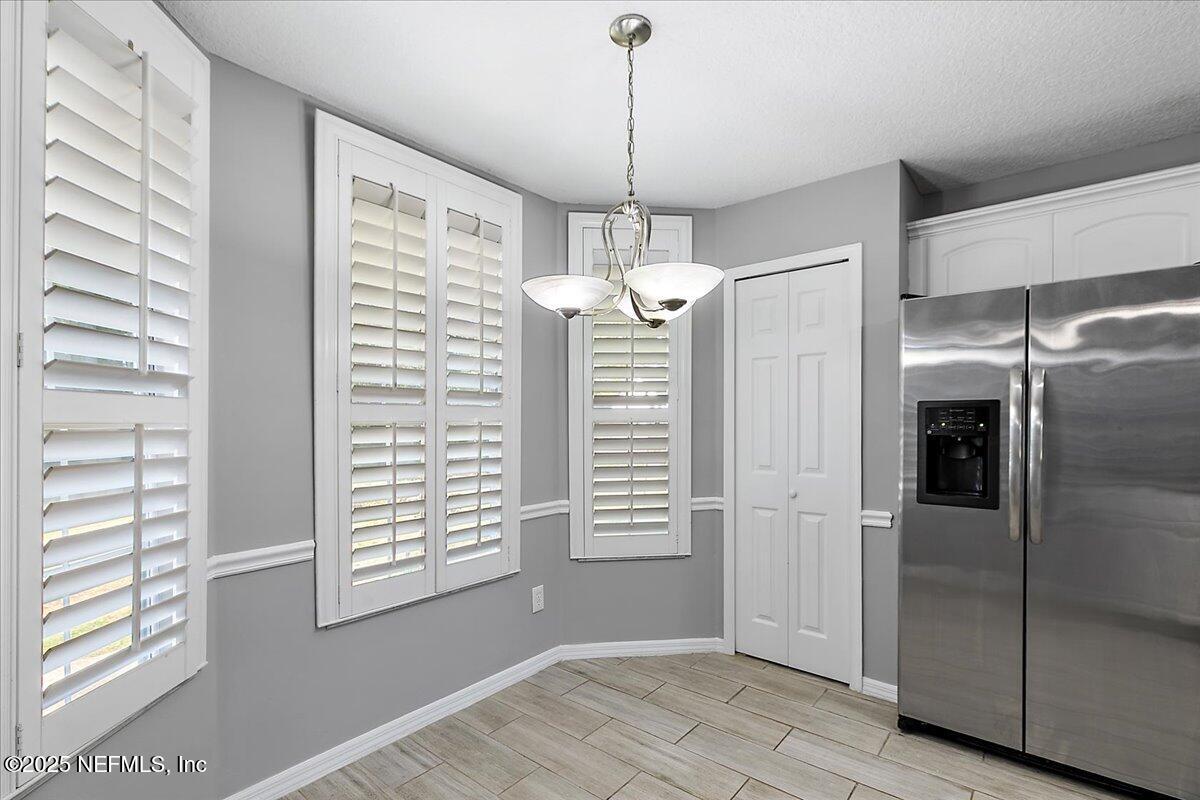 1315 Fruit Cove Road South Jacksonville, FL 32259 - Photo 9 of 19 a view of a hallway with windows and chandelier
