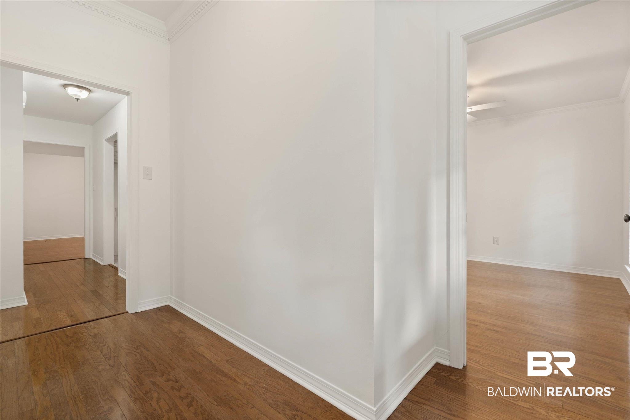 3032 Autumn Ridge Drive West Mobile, AL 36695 - Photo 2 of 20 Hallway with dark wood-style flooring and crown molding