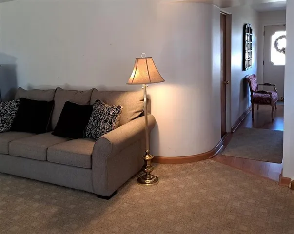 a living room with a couch and a chandelier