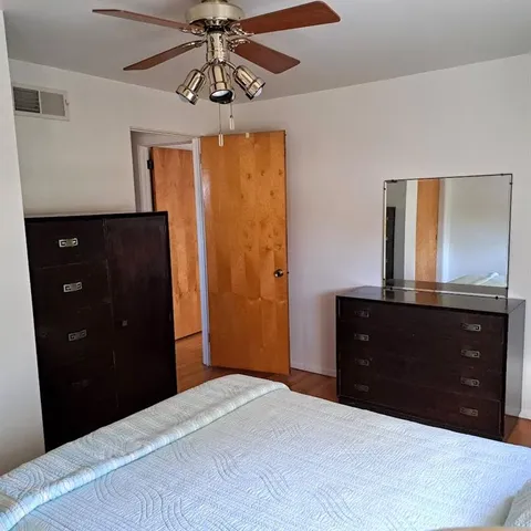 a bedroom with a bed and a dresser