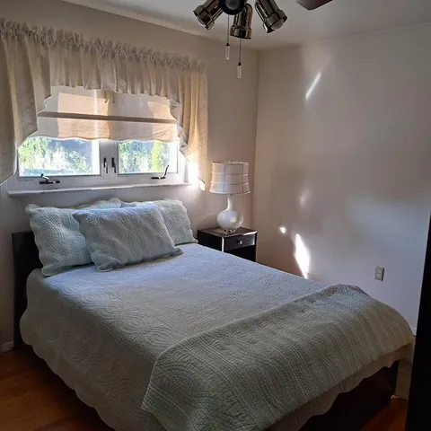 a bedroom with a bed and a window