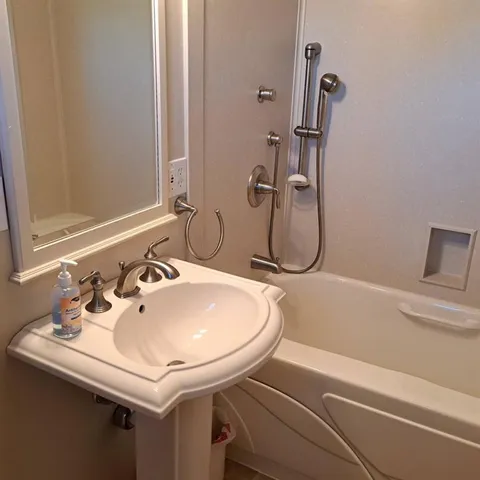 a bathroom with a sink and mirror