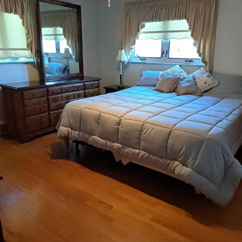 a bedroom with a bed and a large window