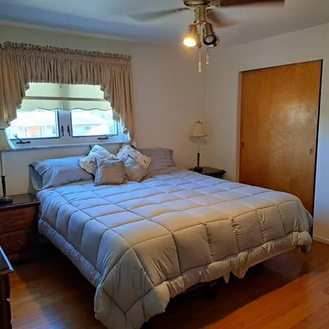 a bedroom with a bed and window