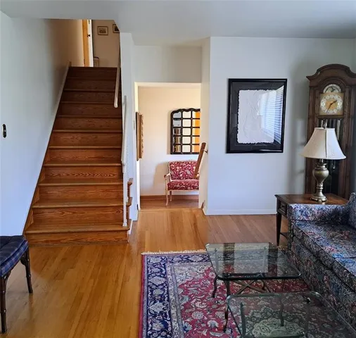 a living room with furniture and a stair