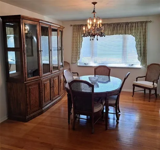a view of a dining room with furniture and chandelier