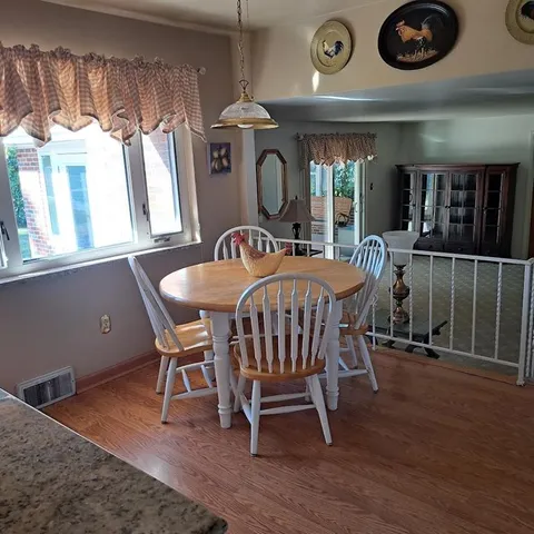 a view of a dining room with furniture window and wooden floor