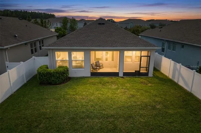 a view of a house with a backyard