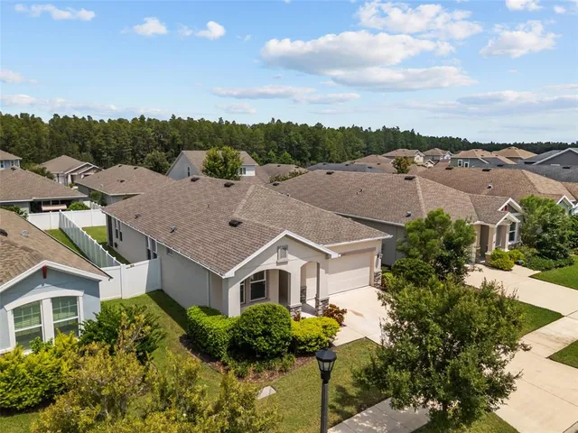 a aerial view of a house with swimming pool and a yard
